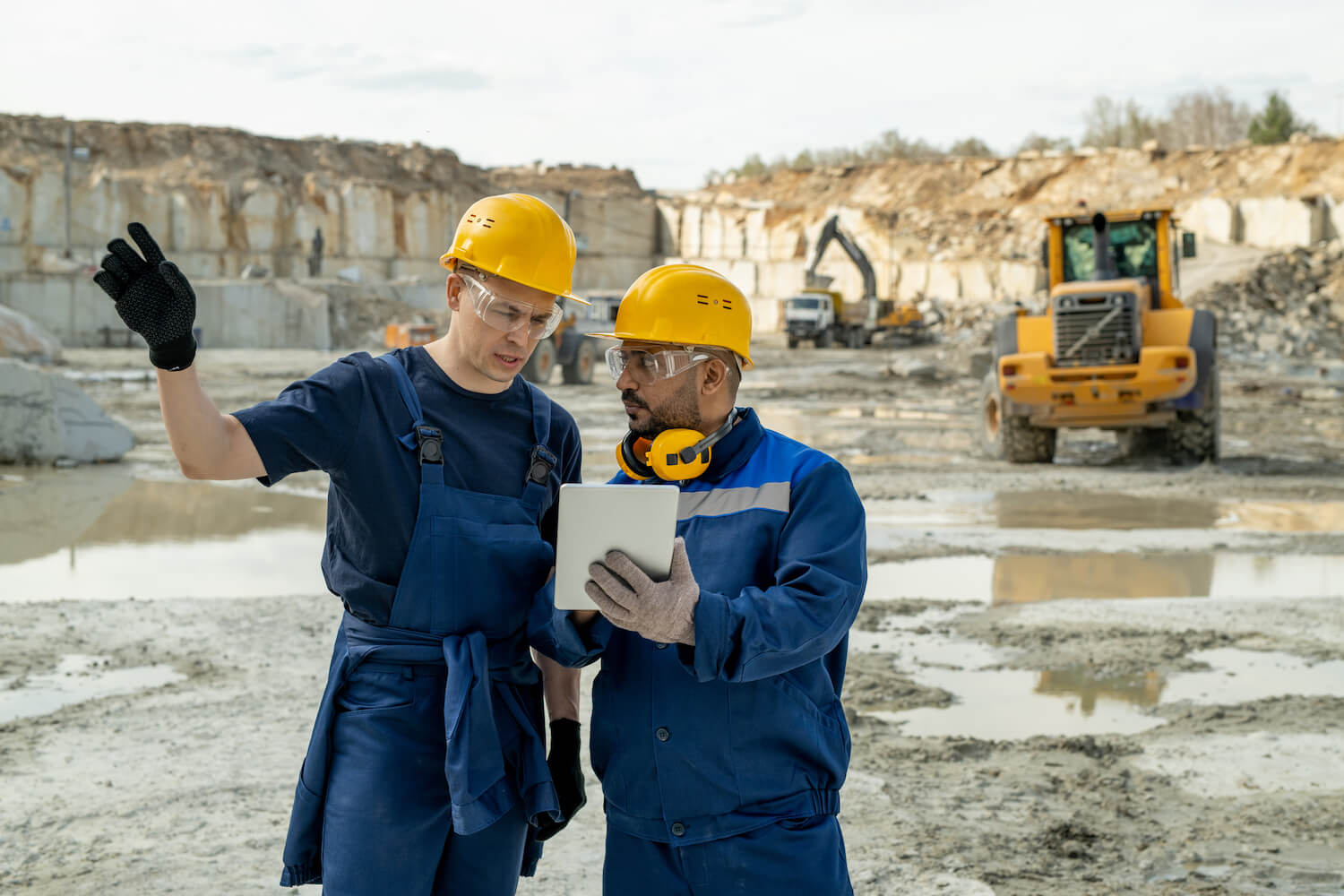 Contemporary builders discussing sketch in tablet